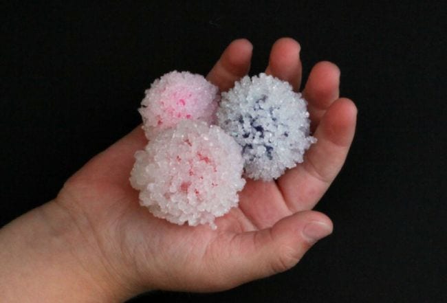 2nd Grade Science A Dab of Glue Will Do Child's hand holding crystal-covered pom pom balls (2nd Grade Science)