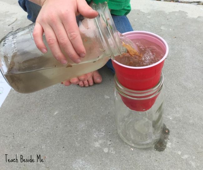 5th Grade Science Water Filtration Teach Beside Me Child pouring dirty water into a cup sitting on top of a large mason jar
