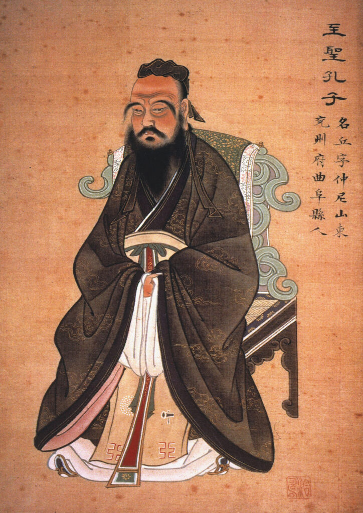 Confucious Famous philosophers include Confucious shown here sitting in a portrait. Chinese writing is on the right side of the painting.