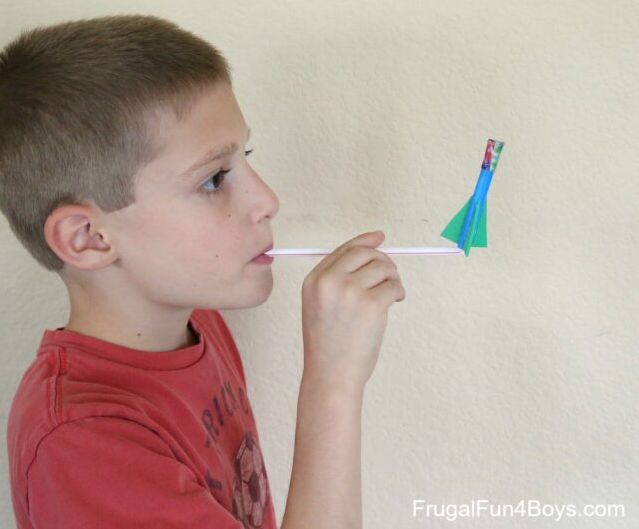 Second Grade Science: Straw Rockets Student blowing on a drinking straw to launch a tiny rocket